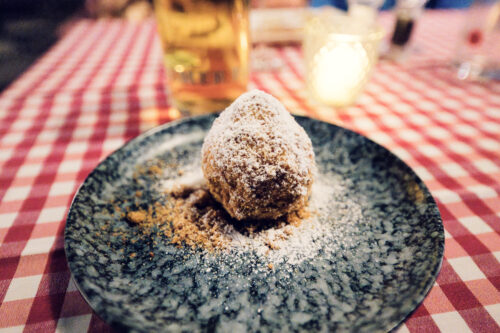 House-made Marillenknödel dusted with sweet breadcrumbs, capturing Vienna's beloved summer dessert.