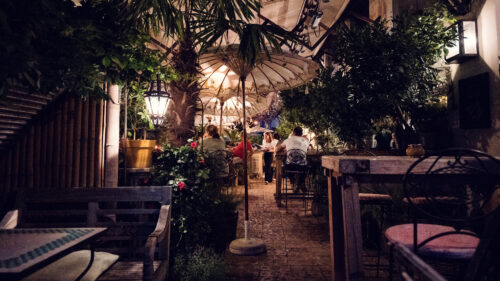 Summer night view of Lucullus Terrace Vienna showing lit outdoor dining area with evening ambiance.
