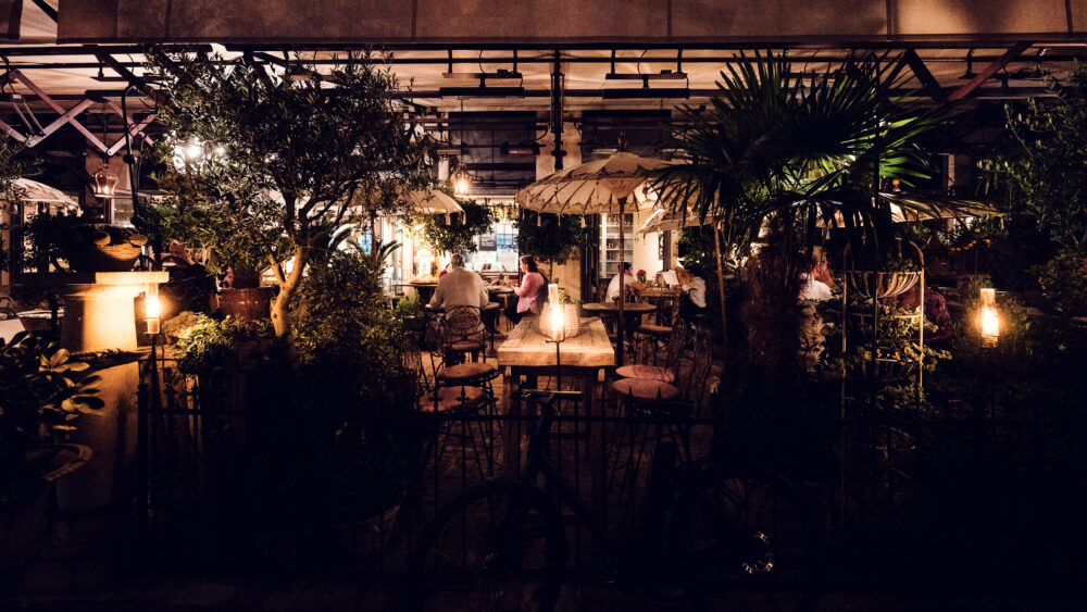 Lucullus Terrace Vienna summer evening with illuminated restaurant terrace and warm night dining atmosphere.