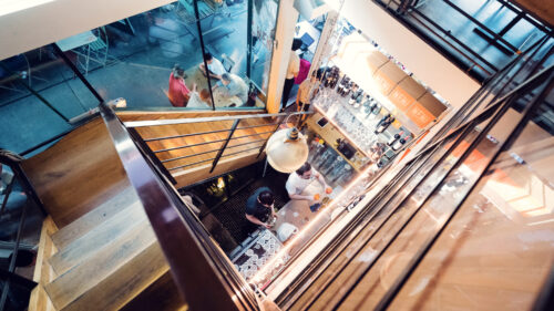 Artistic stairway connecting NENI's dining levels.