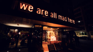 Entrance of Ribelli with its glowing sign and warm lighting on a Vienna street.