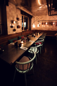 Softly lit dining room at Ribelli during evening hours.