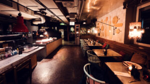 Modern interior of Ribelli Vienna with warm lighting and Italian dining decor.