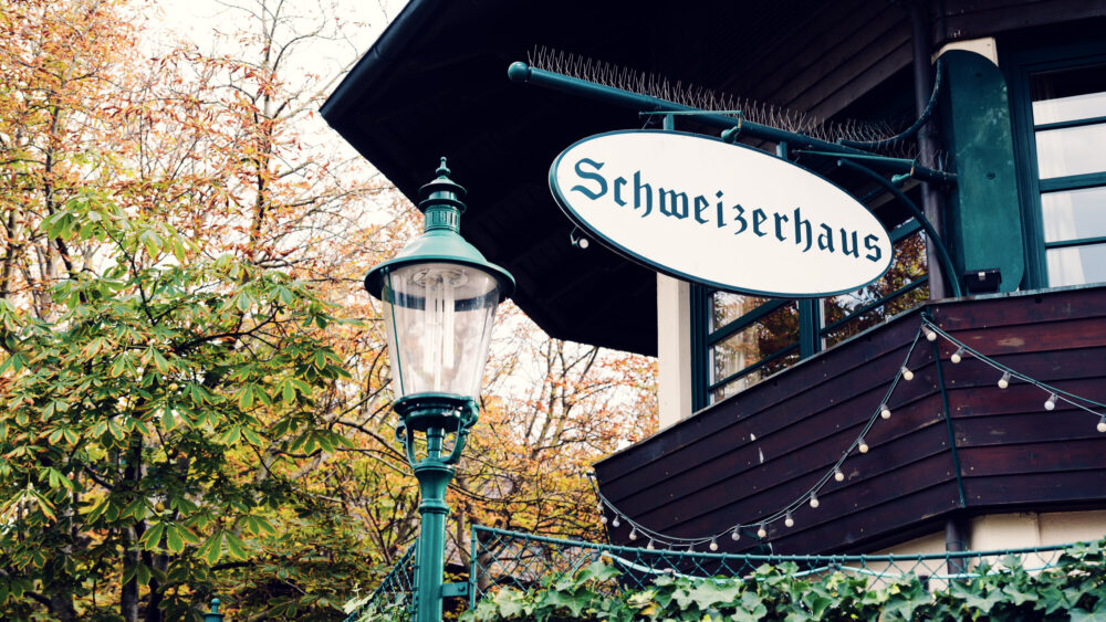 Traditional facade of Schweizerhaus with its characteristic green shutters and historic signage.