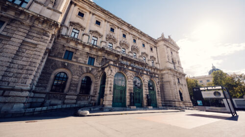 Side perspective of the Weltmuseum Wien's exterior along the curved Neue Burg facade.