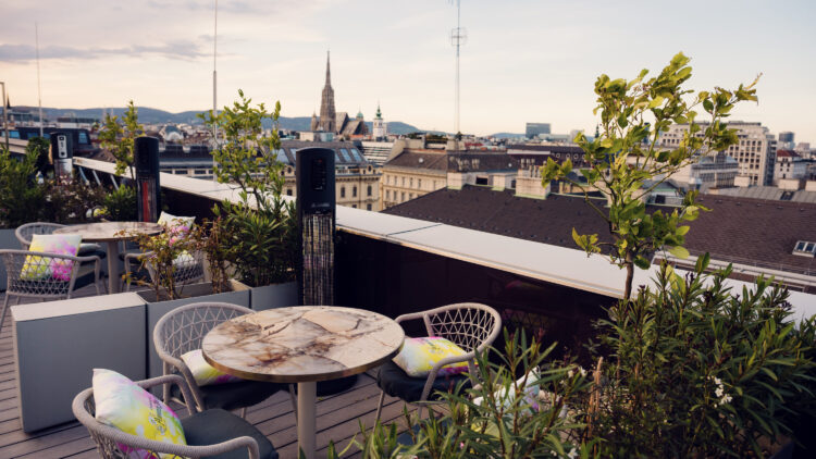 Atmosphere Rooftop Bar's communal lounge area featuring Viennese design elements and skyline backdrop.