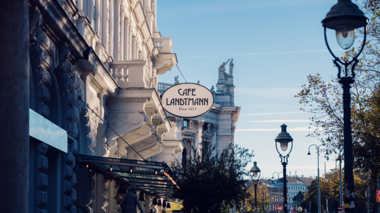 Café Landtmann's Neo-Renaissance facade on Universitätsring 4, with its original 1873 architectural details and outdoor seating area facing the Burgtheater.