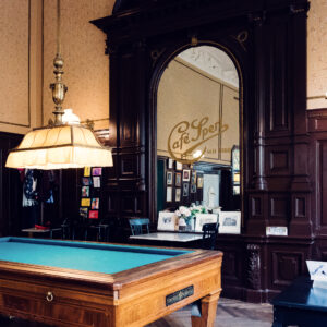 Original billiard room at Café Sperl displaying preserved 1880s interior with historic tables.