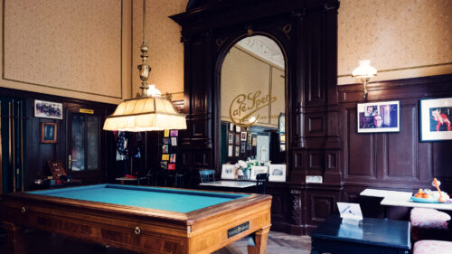 Original billiard room at Café Sperl displaying preserved 1880s interior with historic tables.