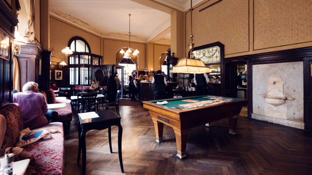 Intimate corner seating at Café Sperl combining historic mirrors and plush benches.