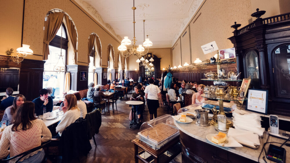 Traditional marble-topped tables at Café Sperl showcasing classic coffee house culture.