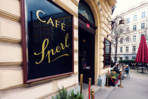 Classic gold-lettered signage at Café Sperl displaying timeless 'CAFE SPERL' typography against traditional facade.