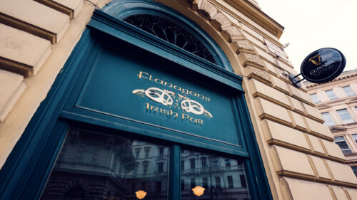 Traditional pub entrance at Flanagan's, where vintage signage create classic Irish atmosphere in Vienna's heart.