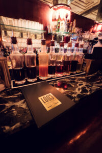 Original bar counter at Loos American Bar, where brass details and marble surfaces demonstrate modernist luxury.