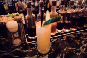 Cocktail preparation at Loos Bar, where premium spirits meet expert mixology.