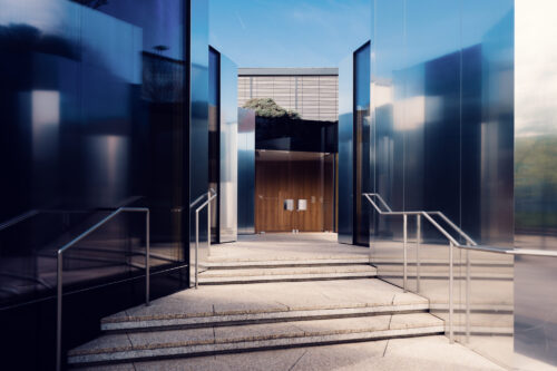 Stone steps leading to the entrance of Steirereck restaurant between mirrored glass walls.