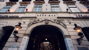Historic entrance archway to the Sünnhof umbrella passage in Vienna.