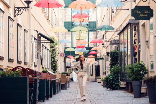 Portrait perspective under colorful umbrella canopy at Sünnhof.