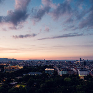 Sunset view from Aurora Rooftop Bar Vienna Austria, golden hour cityscape with panoramic Vienna skyline and evening light over historic city center.