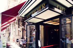 Elegant entrance of Café Sacher Vienna with classic elements.