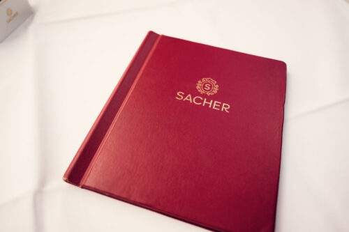 Traditional red leather menu of Café Sacher Vienna.