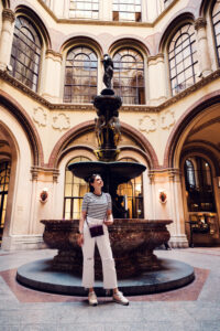 Adriana at the ornate fountain inside Ferstel Passage in Vienna.