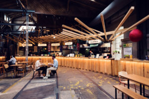 Gleis//Garten Vienna food market in a former railway carriage shed with restaurants, bars, and brewery.