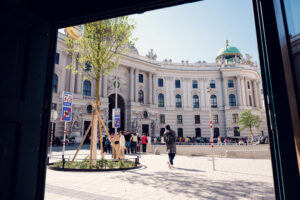 Michaelerplatz in Vienna with the Roman excavation site and the curved Baroque facade of the Hofburg Michaelertrakt.