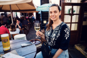 Adriana cheering with wine glass at Wiener Salm Bräu Vienna.