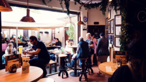 Dining room with wooden tables and bench seating inside Salm Bräu.