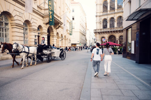 Adriana and Mario walking near historic Café Central Vienna, traditional Viennese coffeehouse architecture in First District Inner City.