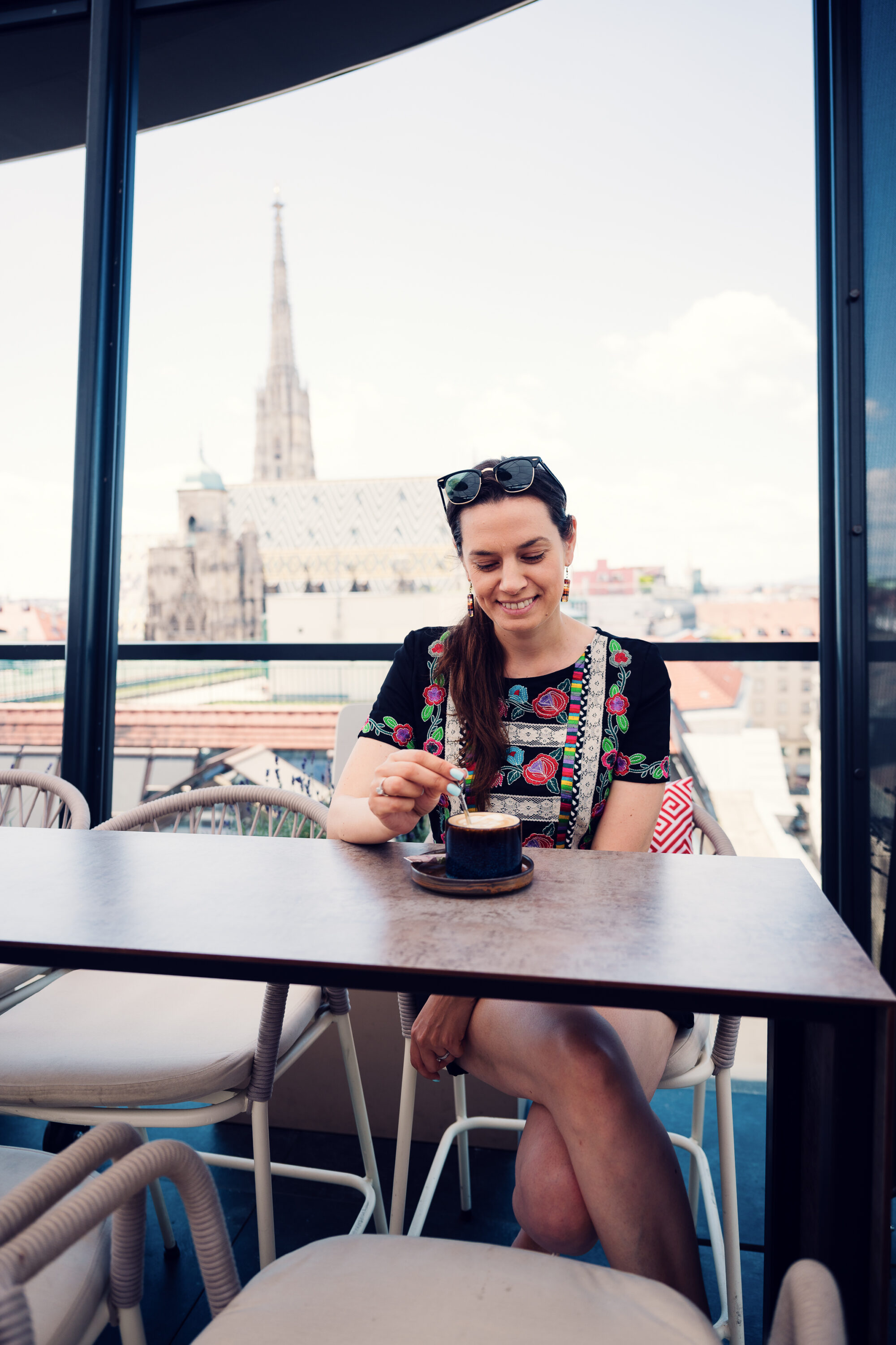 Adriana enjoying coffee at Lamee Rooftop Bar in Vienna.