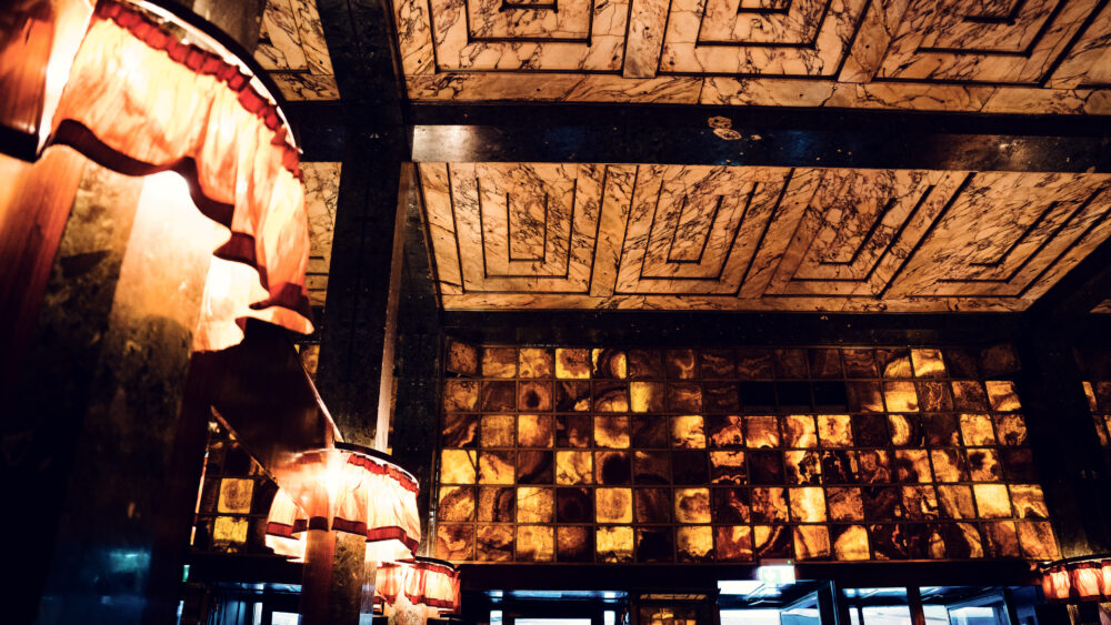 Loos Bar Vienna interior with Art Deco design and dark wood paneling.