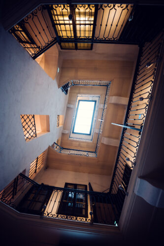 Wooden staircase with wrought-iron handrails inside Mozarthaus.
