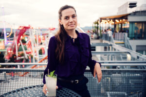 Adriana posing on Zoku Vienna rooftop terrace with Prater skyline view.