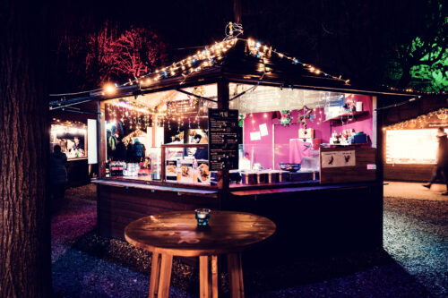 Hot beverage stand at Christmas village in Altes AKH historic courtyard.