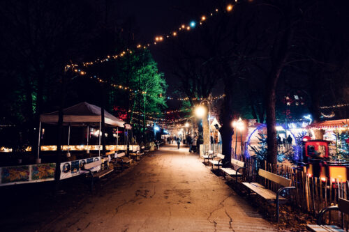 Christmas village pathway between wooden chalets in Altes AKH inner courtyard.