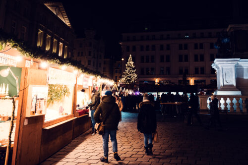 Crowd walking through Christmas market at Am Hof square Vienna.