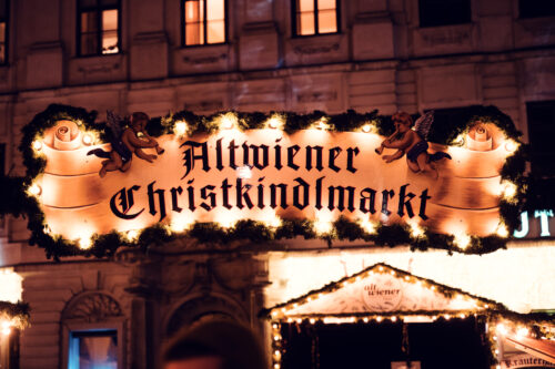 Historic Freyung square hosting Altwiener Christkindlmarkt with surrounding baroque buildings.