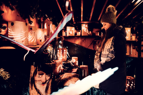 Adriana at traditional wooden art stalls at Art Advent Karlsplatz.