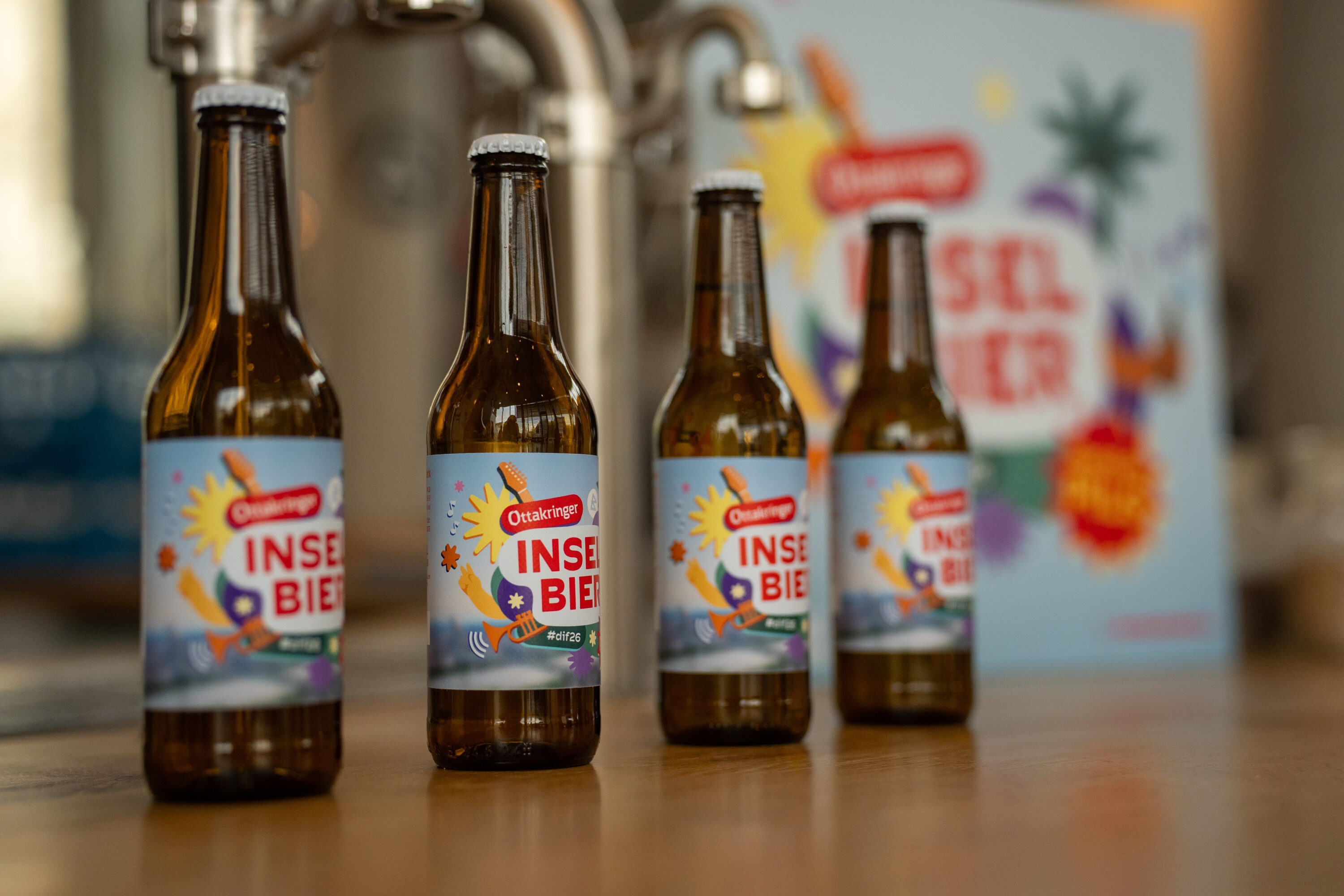 Bottles of Ottakringer Inselbier with dif26 branding, the official beer of Donauinselfest
